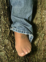 Stunning milf in pantyhose takes off clothes and poses near tree